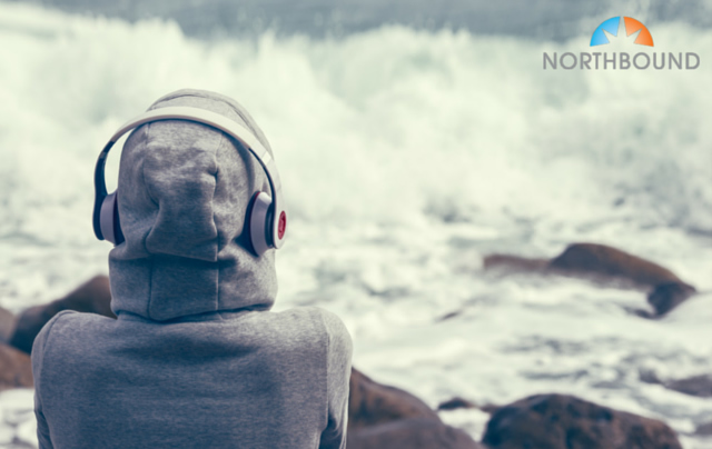 A recovering addict listening to music at the beach